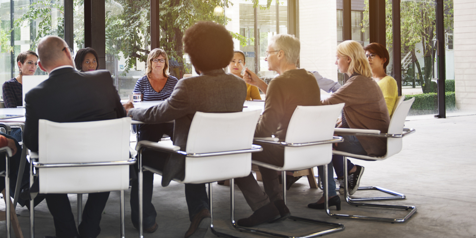 people sitting around table in meeting